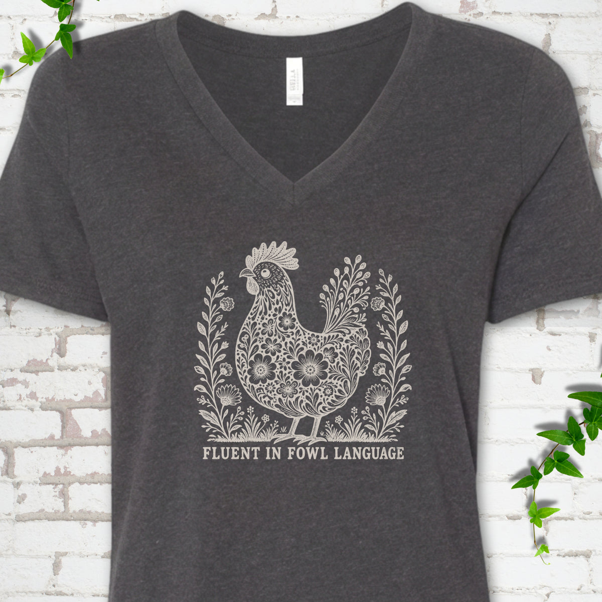 Dark Grey Heather Bella Canvas® V-neck T-shirt with cream floral hen and Fluent in Fowl Language text