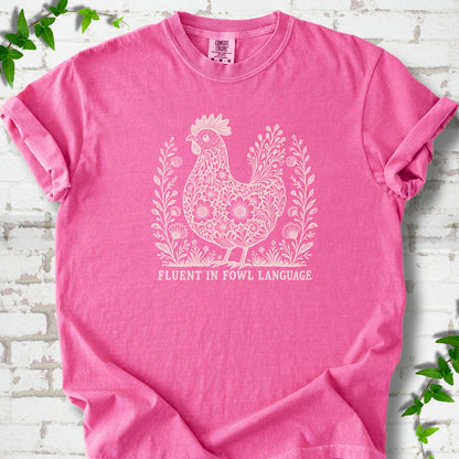 Crunchberry Comfort Colors® T-shirt with cream floral hen and Fluent in Fowl Language text