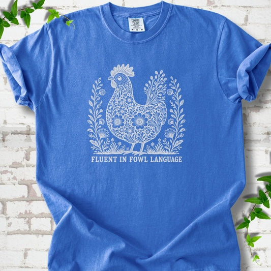Flo Blue Comfort Colors® T-shirt with cream floral hen and Fluent in Fowl Language text