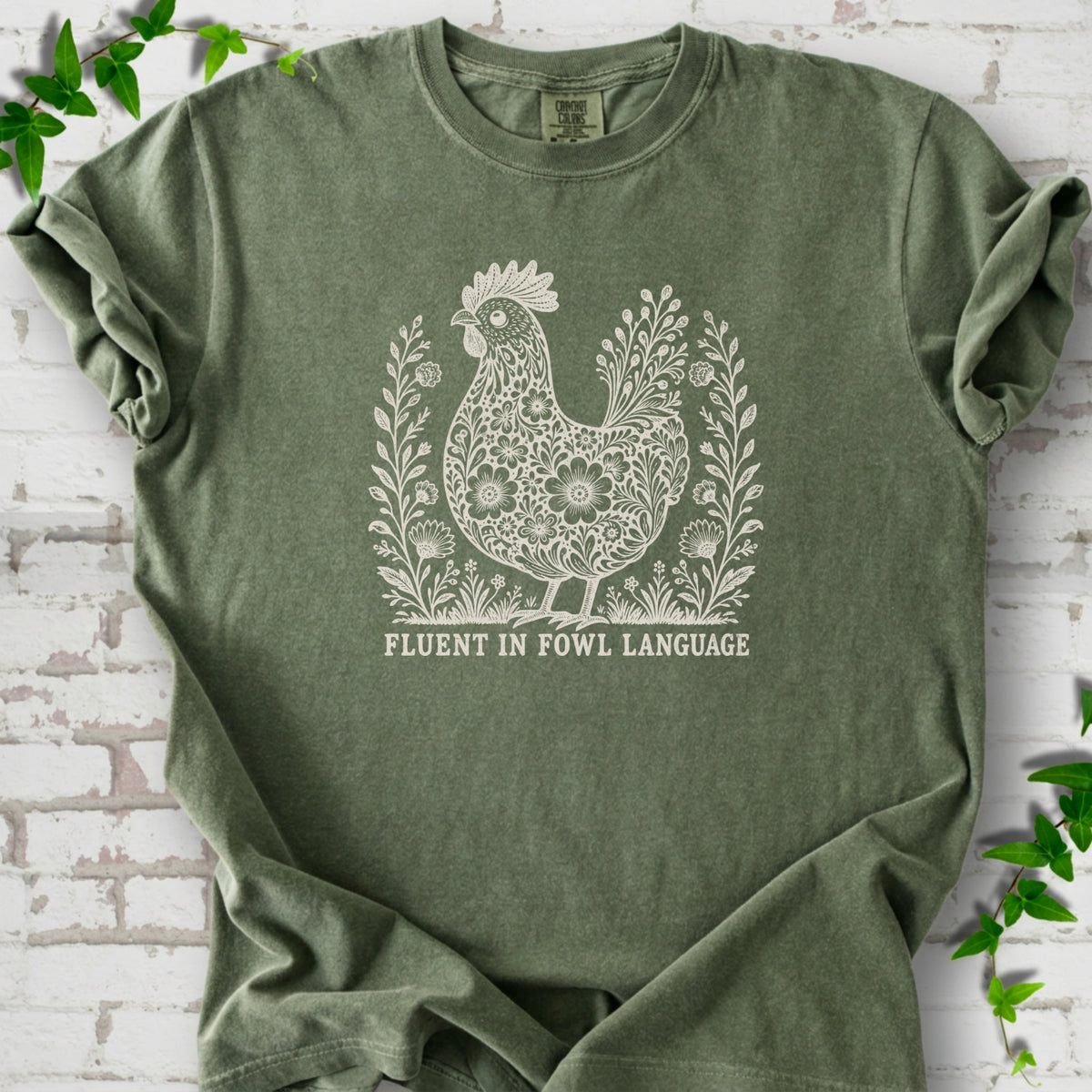 Moss Comfort Colors® T-shirt with cream floral hen and Fluent in Fowl Language text