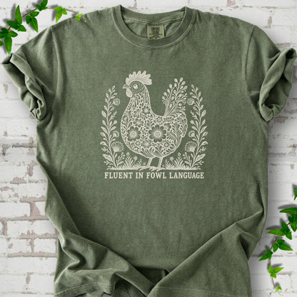 Moss Comfort Colors® T-shirt with cream floral hen and Fluent in Fowl Language text
