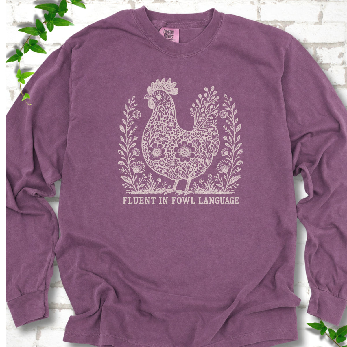 Berry Comfort Colors® long sleeve T-shirt with cream floral hen and Fluent in Fowl Language text