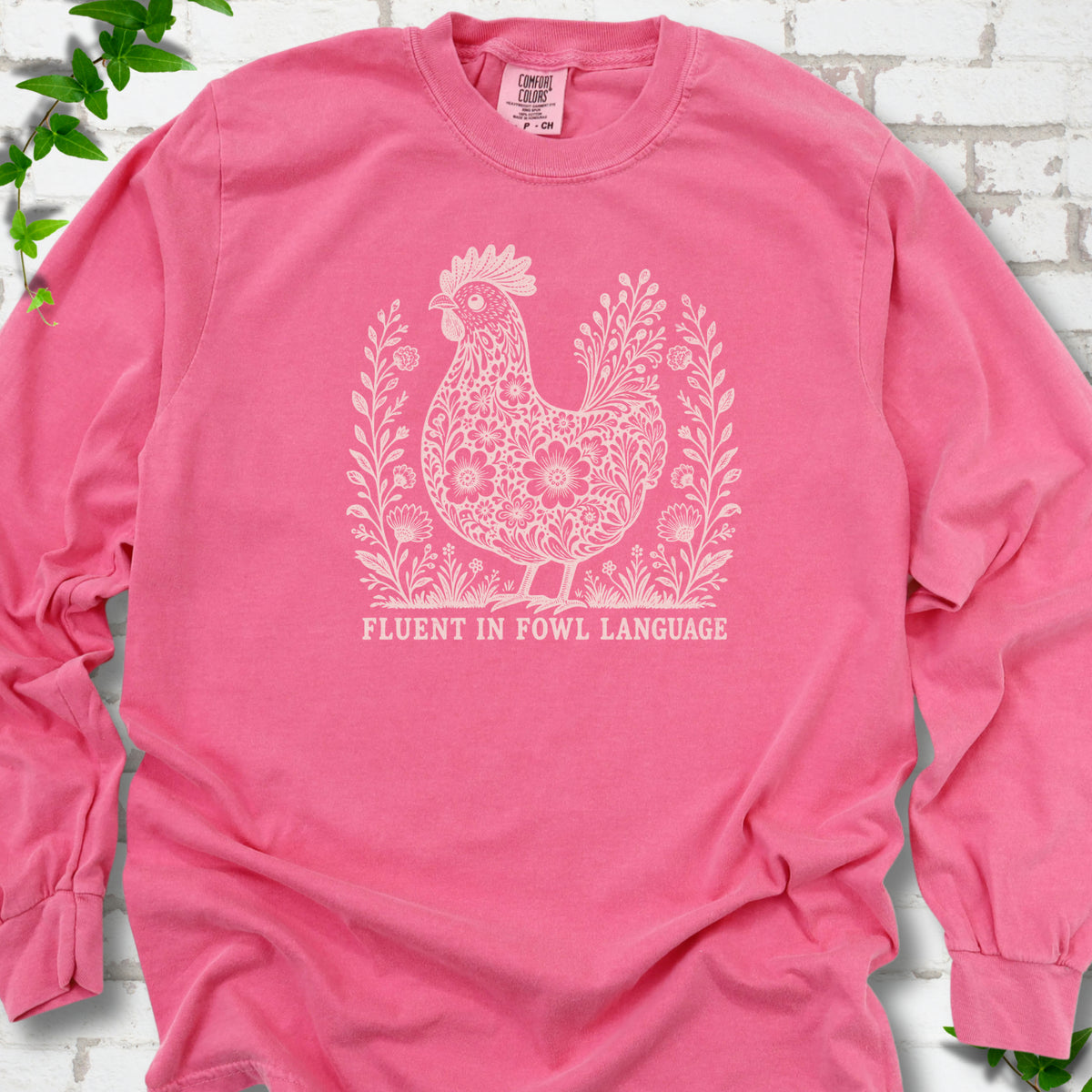 Crunchberry Comfort Colors® long sleeve T-shirt with cream floral hen and Fluent in Fowl Language text