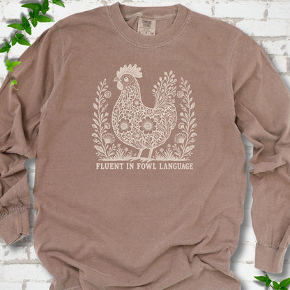 Espresso Comfort Colors® long sleeve T-shirt with cream floral hen and Fluent in Fowl Language text