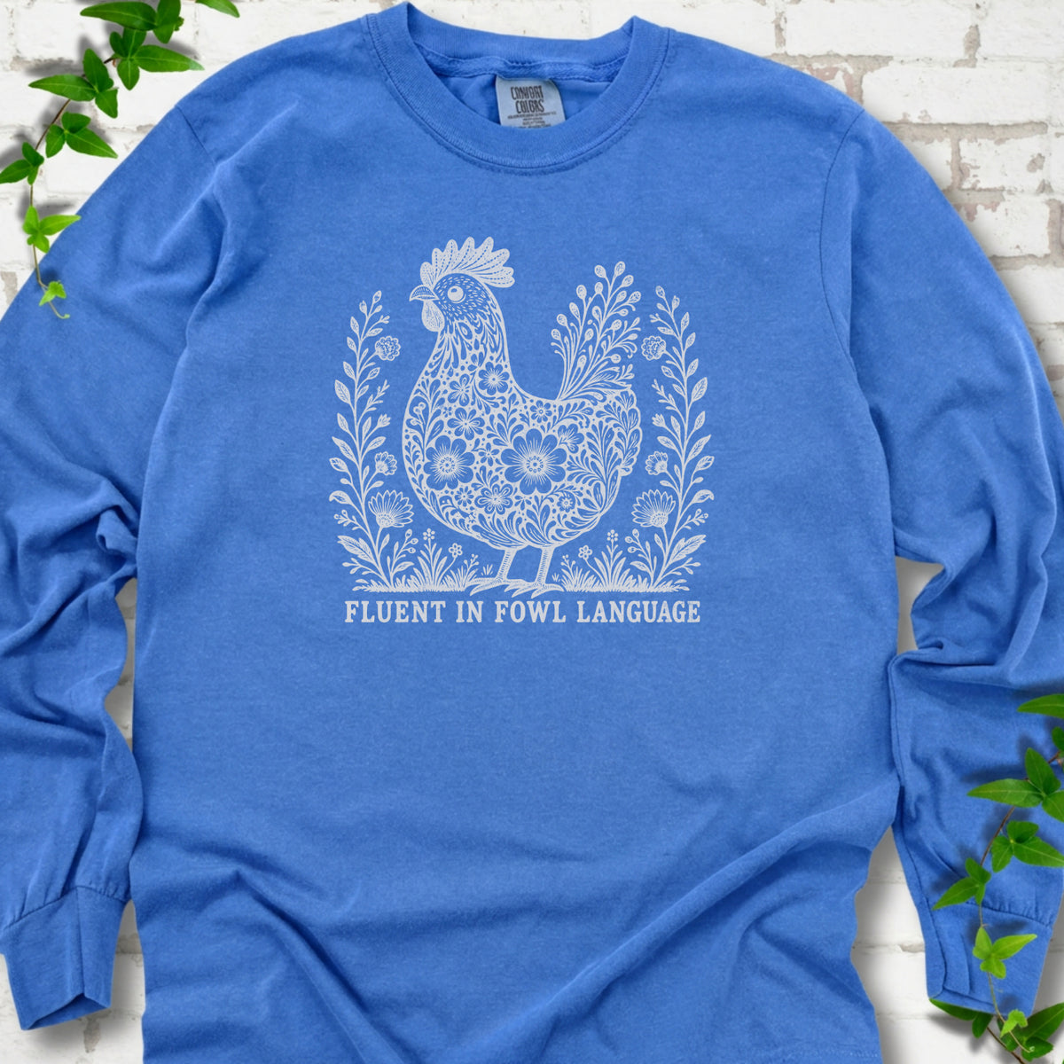 Flo Blue Comfort Colors® long sleeve T-shirt with cream floral hen and Fluent in Fowl Language text