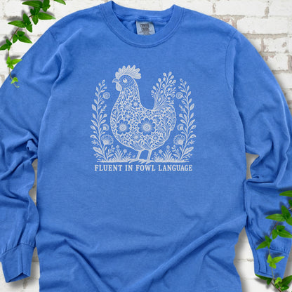 Flo Blue Comfort Colors® long sleeve T-shirt with cream floral hen and Fluent in Fowl Language text