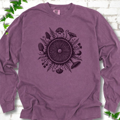 Berry purple long-sleeve tee with a mushroom gill circle ringed by ferns, morels and mushrooms in dark plum ink.