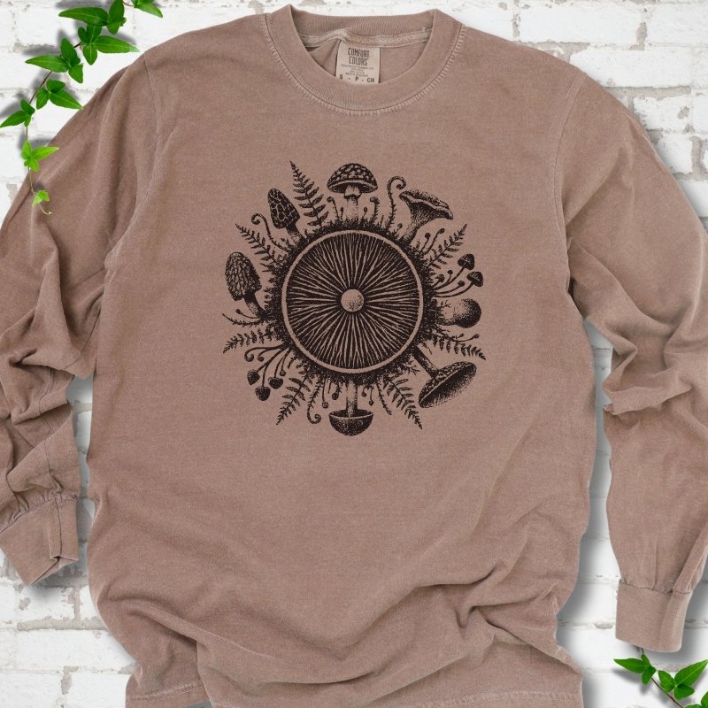 Espresso brown long-sleeve tee with a mushroom gill circle ringed by ferns, morels and mushrooms in dark brown ink.