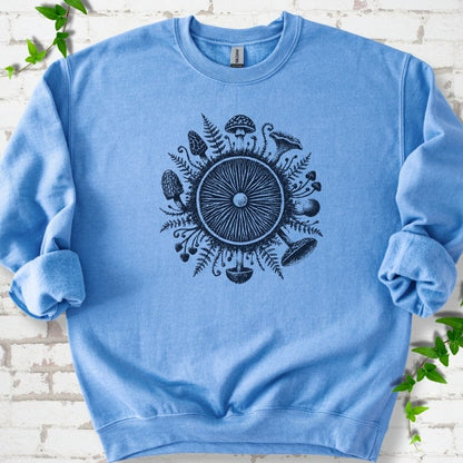 Carolina Blue crewneck sweatshirt with a mushroom gill circle ringed by ferns, morels and mushrooms in navy ink.