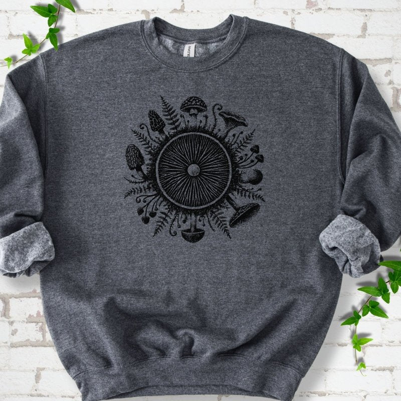 Dark Heather gray crewneck sweatshirt with a mushroom gill circle ringed by ferns, morels and mushrooms in black ink.
