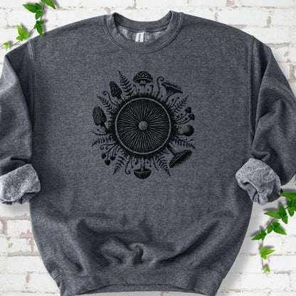 Dark Heather gray crewneck sweatshirt with a mushroom gill circle ringed by ferns, morels and mushrooms in black ink.