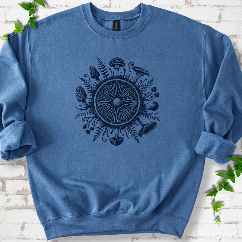 Indigo blue crewneck sweatshirt with a mushroom gill circle ringed by ferns, morels and mushrooms in navy ink.