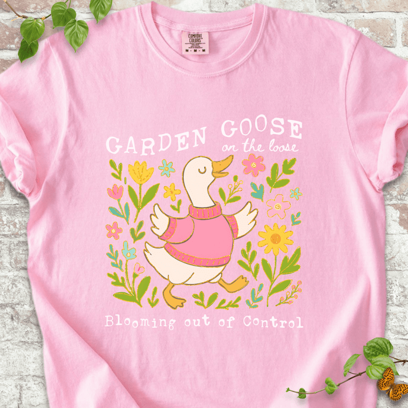 Silly gardening goose graphic on a blossom pink Comfort Colors™ T-shirt with a flower-loving goose in full bloom.