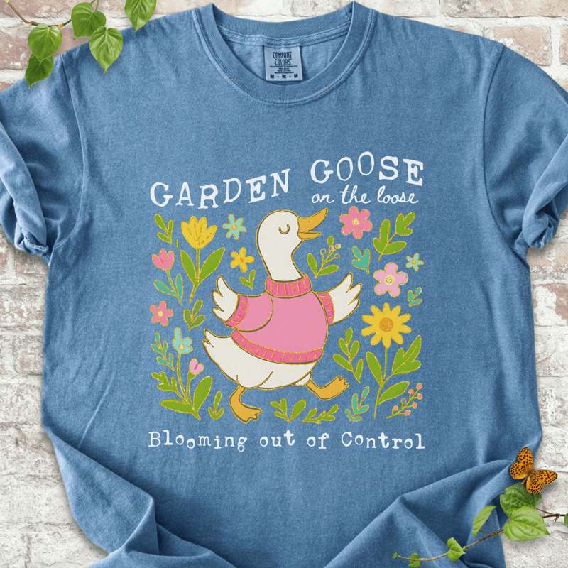 Silly gardening goose graphic on a blue jean Comfort Colors™ T-shirt with a flower-loving goose in full bloom.