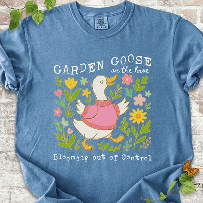 Silly gardening goose graphic on a blue jean Comfort Colors™ T-shirt with a flower-loving goose in full bloom.