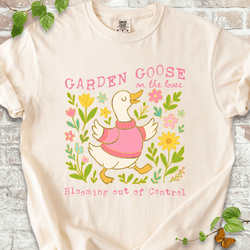 Silly gardening goose graphic on an ivory Comfort Colors™ T-shirt with a flower-loving goose in full bloom.