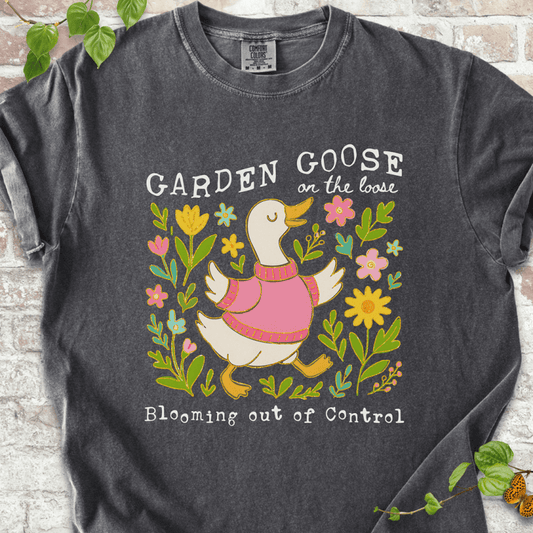 Silly gardening goose graphic on a pepper Comfort Colors™ T-shirt with a flower-loving goose in full bloom.