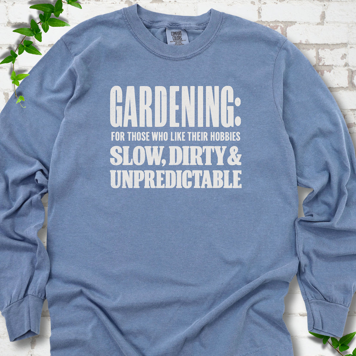 Blue Jean Comfort Colors® long sleeve T-shirt with white “Gardening: For Those Who Like Their Hobbies Slow, Dirty & Unpredictable” typography
