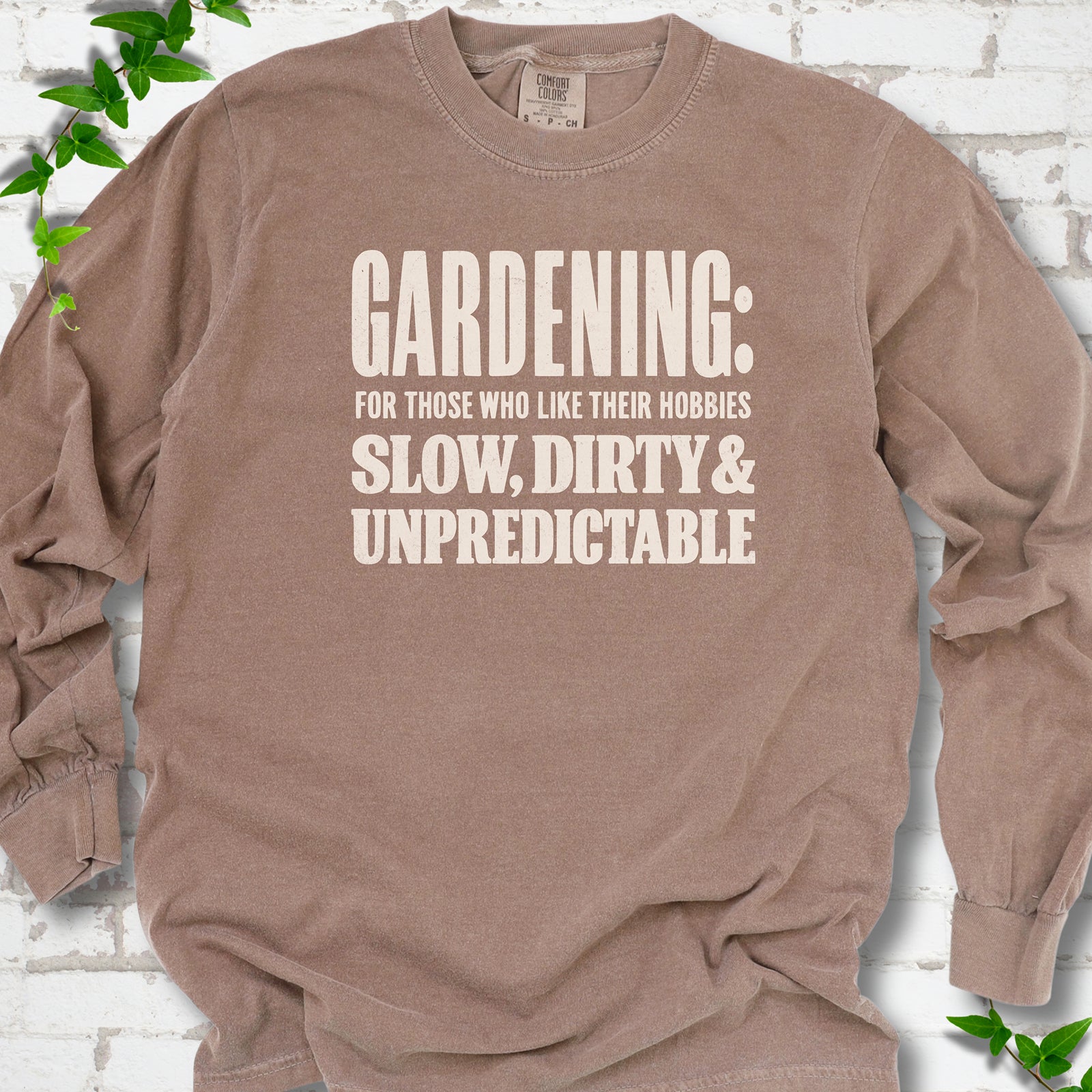 Espresso Comfort Colors® long sleeve T-shirt with white “Gardening: For Those Who Like Their Hobbies Slow, Dirty & Unpredictable” typography