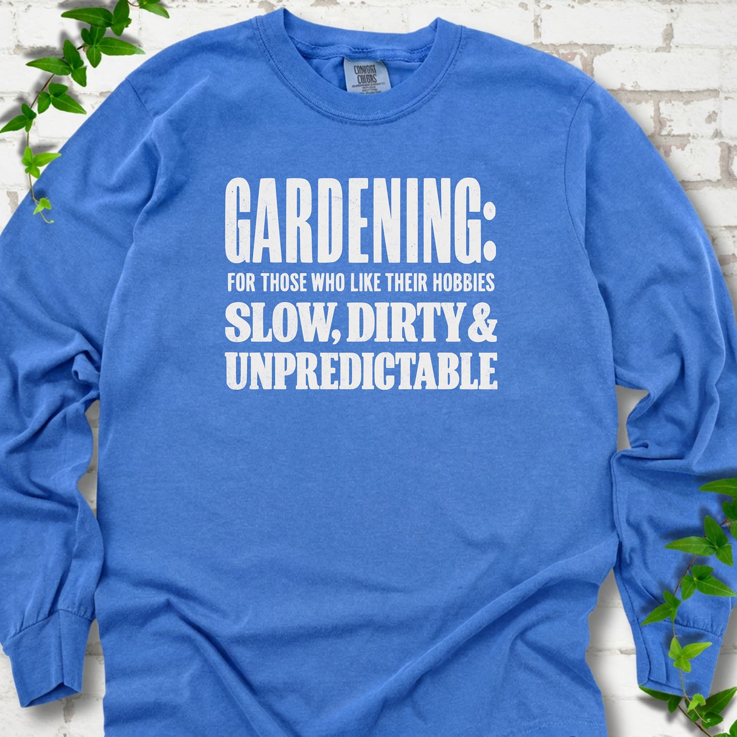 Flo Blue Comfort Colors® long sleeve T-shirt with white “Gardening: For Those Who Like Their Hobbies Slow, Dirty & Unpredictable” typography
