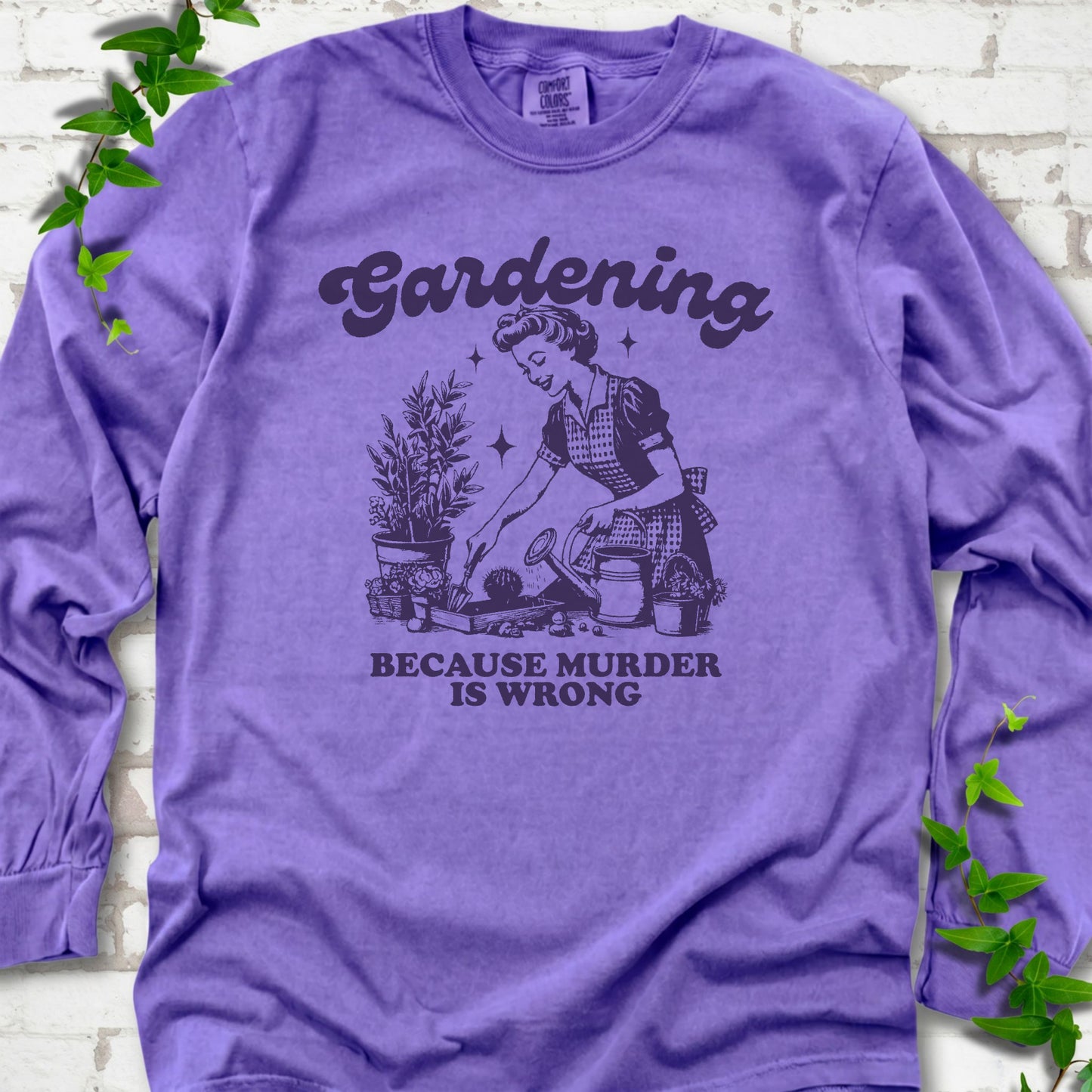 Violet Comfort Colors® long sleeve T-shirt flat lay with retro Gardening Because Murder is Wrong artwork.
