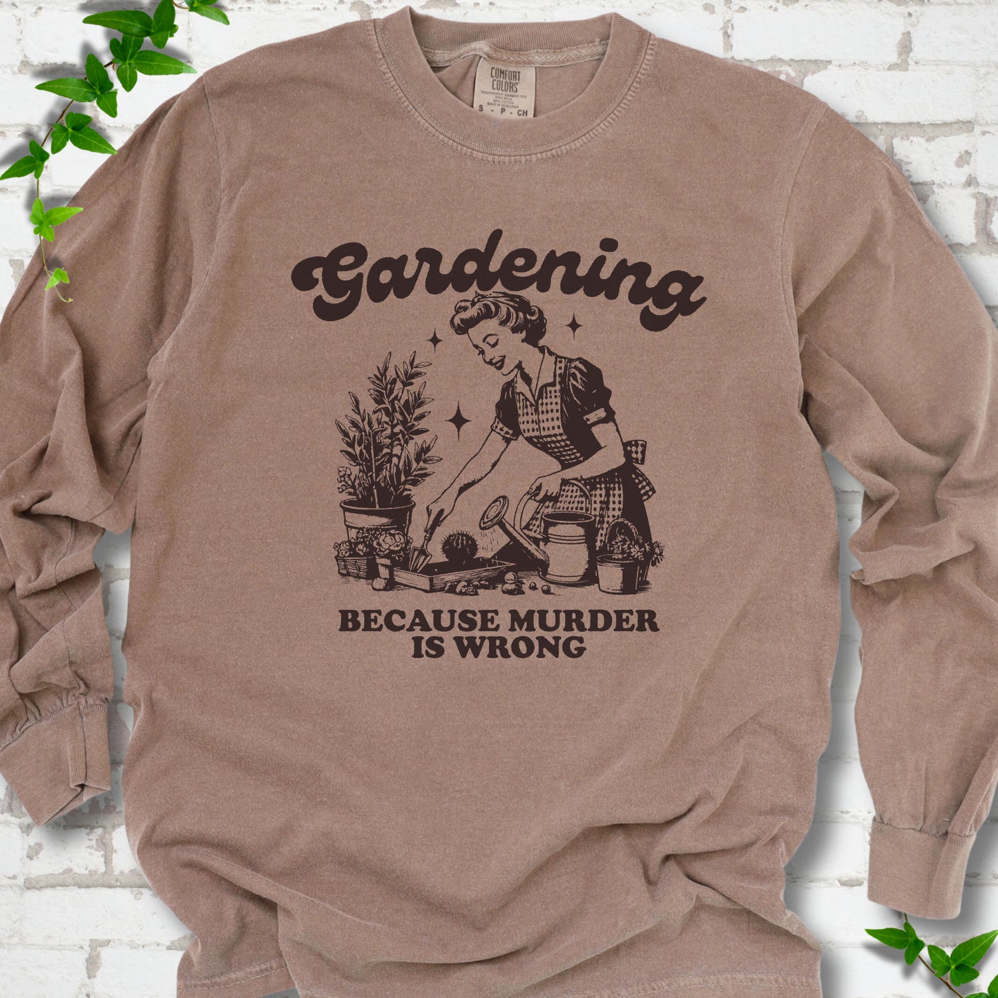 Espresso Comfort Colors® long sleeve T-shirt flat lay with retro Gardening Because Murder is Wrong artwork.