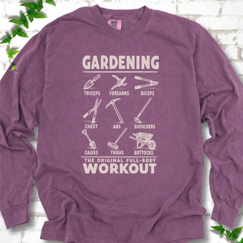 Berry Comfort Colors® long sleeve T-shirt flat lay featuring a distressed Gardening full-body workout design with labelled garden tools and wheelbarrow.