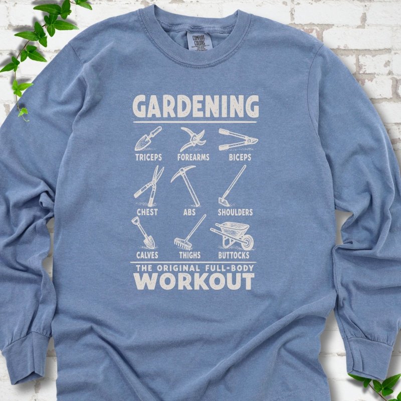 Blue Jean Comfort Colors® long sleeve T-shirt flat lay featuring a distressed Gardening full-body workout design with labelled garden tools and wheelbarrow.