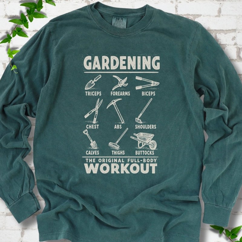 Blue Spruce Comfort Colors® long sleeve T-shirt flat lay featuring a distressed Gardening full-body workout design with labelled garden tools and wheelbarrow.