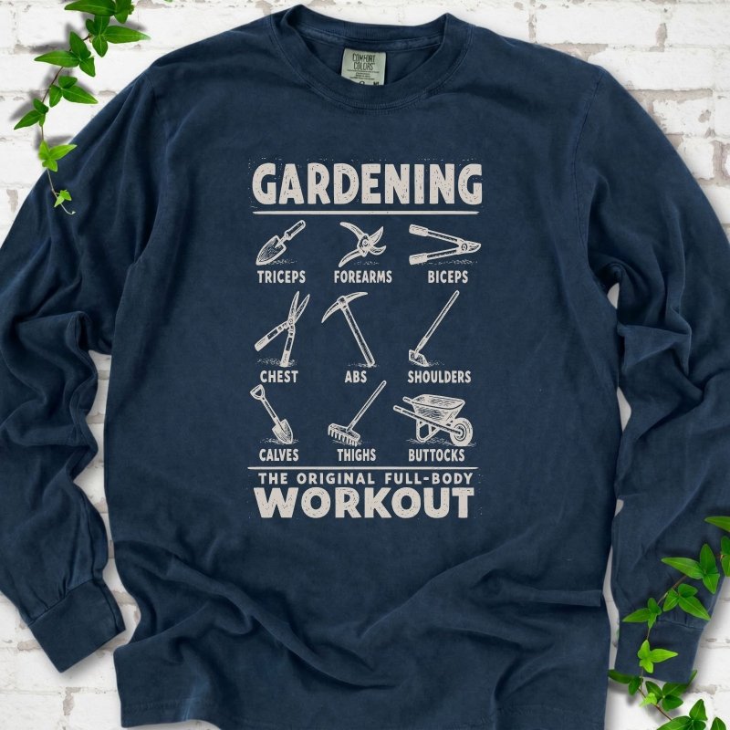 Midnight Comfort Colors® long sleeve T-shirt flat lay featuring a distressed Gardening full-body workout design with labelled garden tools and wheelbarrow.