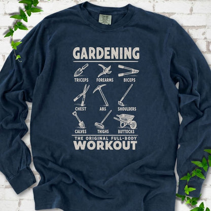 Midnight Comfort Colors® long sleeve T-shirt flat lay featuring a distressed Gardening full-body workout design with labelled garden tools and wheelbarrow.
