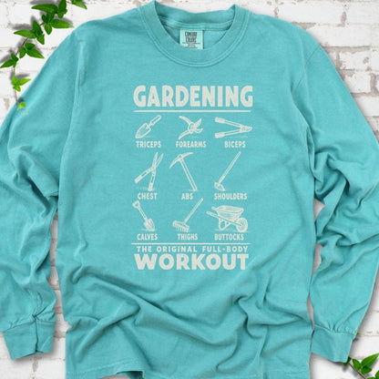 Seafoam Comfort Colors® long sleeve T-shirt flat lay featuring a distressed Gardening full-body workout design with labelled garden tools and wheelbarrow.
