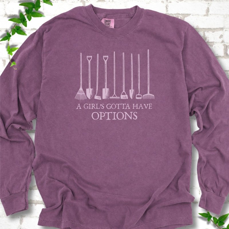 Berry Comfort Colors® long sleeve T-shirt with A Girl's Gotta Have Options garden tools graphic