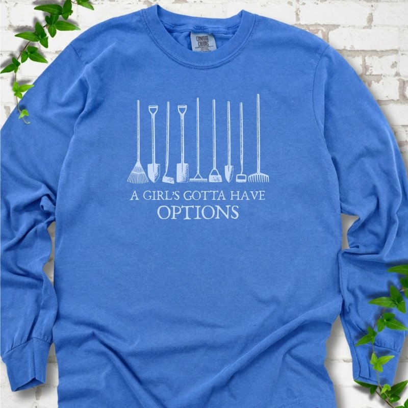 Flo Blue Comfort Colors® long sleeve T-shirt with A Girl's Gotta Have Options garden tools graphic