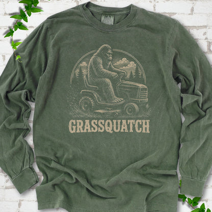 Hemp Comfort Colors® long sleeve T-shirt front mockup featuring Bigfoot riding a lawn mower above the word Grassquatch.