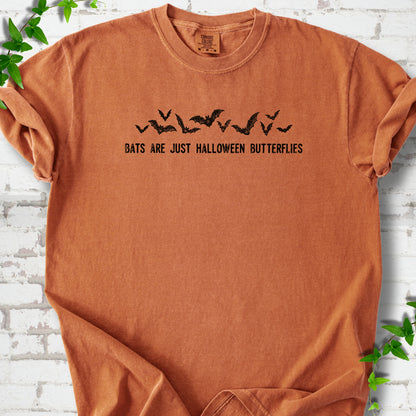 Yam Comfort Colors® T-shirt flat lay with black flying bats and “Bats Are Just Halloween Butterflies” lettering.