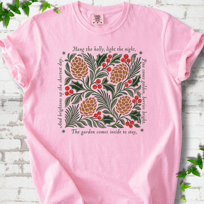 Blossom Comfort Colors® T-shirt shown flat with green holly, red berries, pine cones and the "Hang the Holly" seasonal verse