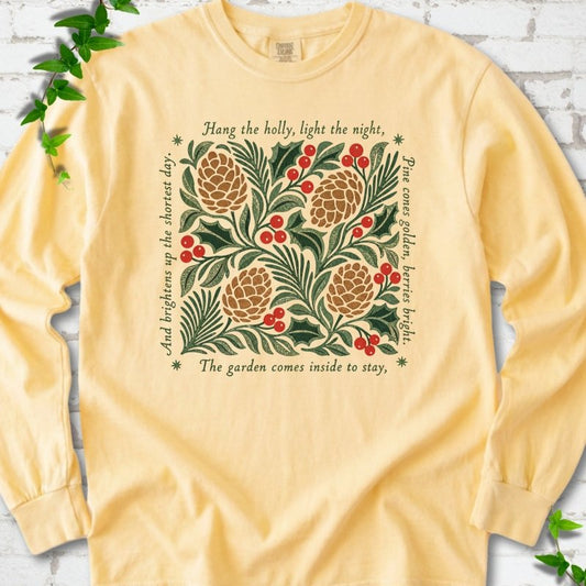 Butter Comfort Colors® long sleeve T-shirt shown flat with green holly, red berries, pine cones and the "Hang the Holly" seasonal verse