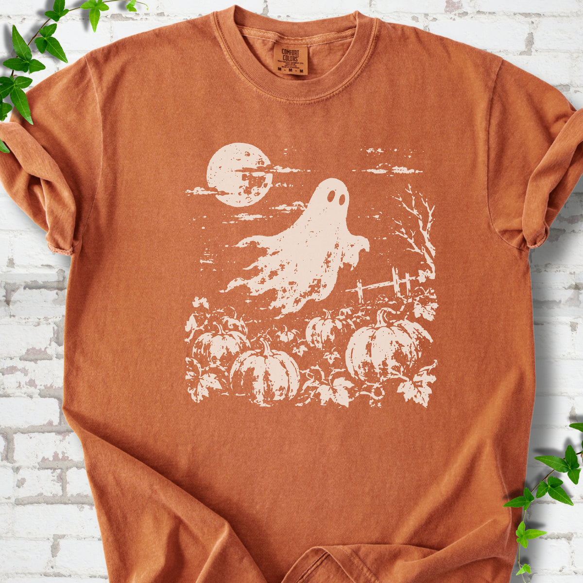 Yam Comfort Colors® T-shirt flat lay featuring a distressed ghost floating above a pumpkin patch beneath a full moon.