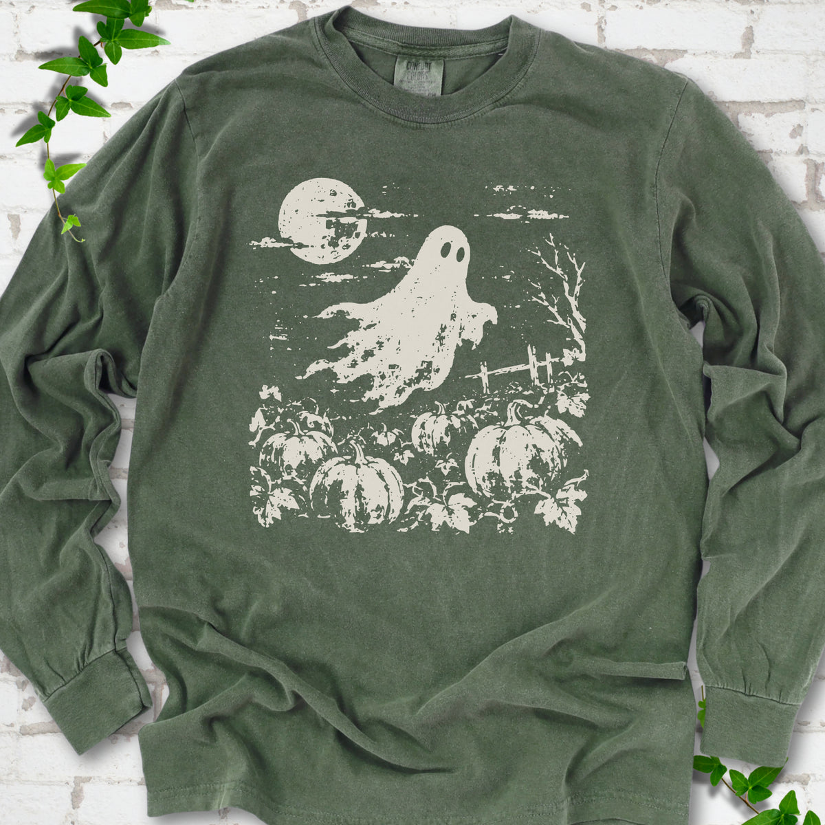 Hemp Comfort Colors® long sleeve tee flat lay featuring a distressed ghost floating above a pumpkin patch beneath a full moon.