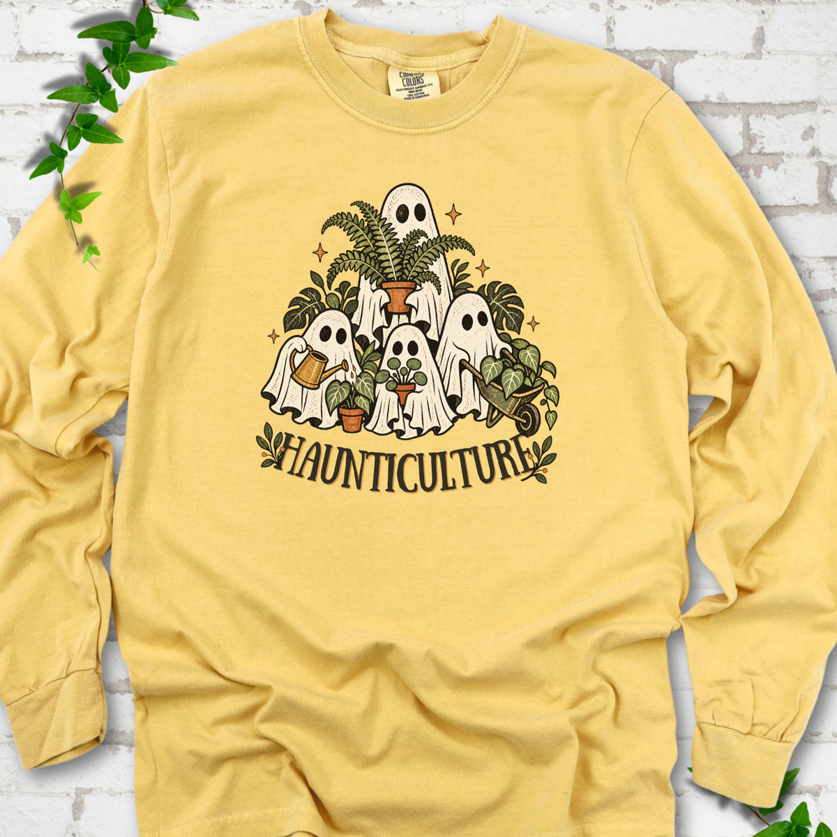 Mustard Comfort Colors® long sleeve T-shirt featuring four friendly gardening ghosts with houseplants and the word Haunticulture