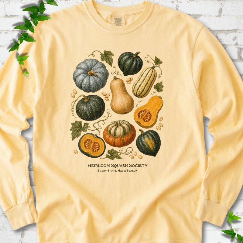 Butter Comfort Colors® long sleeve T-shirt flat lay featuring an illustrated collection of heirloom squash, pumpkins, seeds and vines with text "Heirloom Squash Society" and "Every shape has a season"