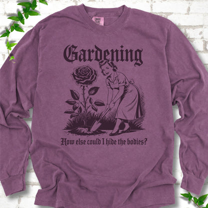 Berry Comfort Colors® long sleeve T-shirt flat lay with black Hide the Bodies retro gardening artwork.