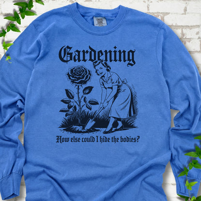 Flo Blue Comfort Colors® long sleeve T-shirt flat lay with black Hide the Bodies retro gardening artwork.