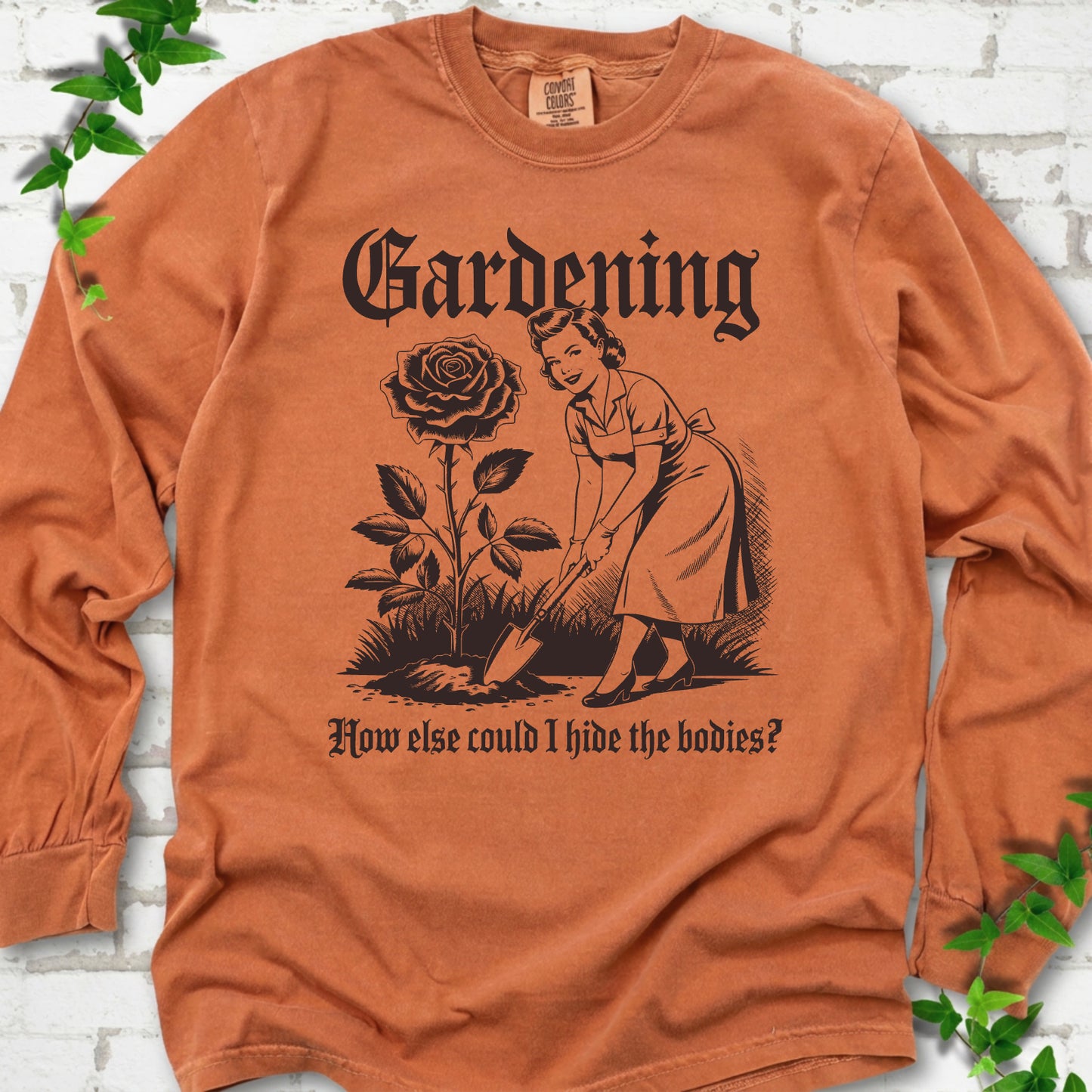 Yam Comfort Colors® long sleeve T-shirt flat lay with black Hide the Bodies retro gardening artwork.