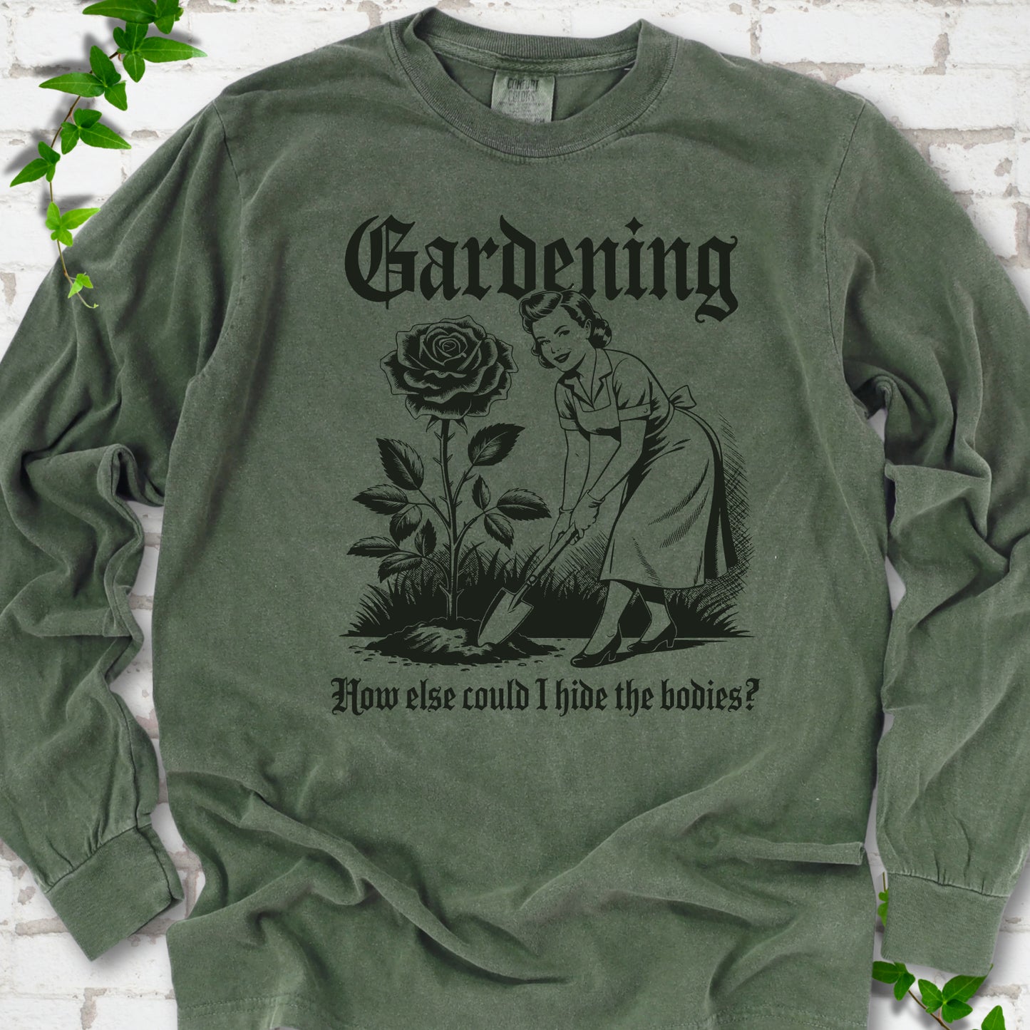 Hemp Comfort Colors® long sleeve T-shirt flat lay with black Hide the Bodies retro gardening artwork.