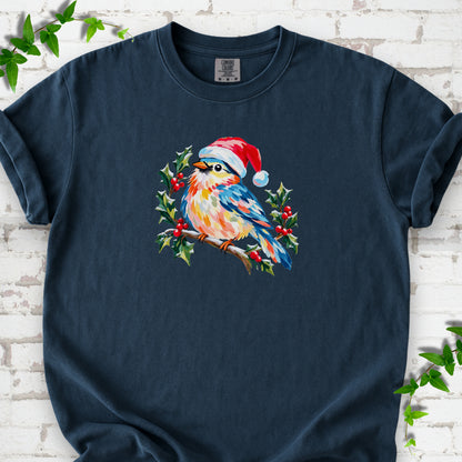 Midnight T-shirt laid flat, featuring a colorful songbird in a red festive hat perched among holly leaves and berries.