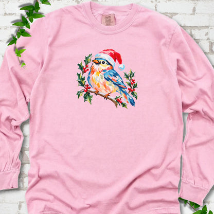 Blossom long sleeve T-shirt laid flat, featuring a colorful songbird in a red festive hat perched among holly leaves and berries.