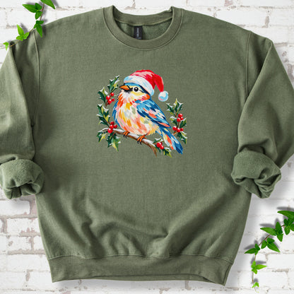 Military Green classic sweatshirt laid flat, featuring a colorful songbird in a red festive hat perched among holly leaves and berries.