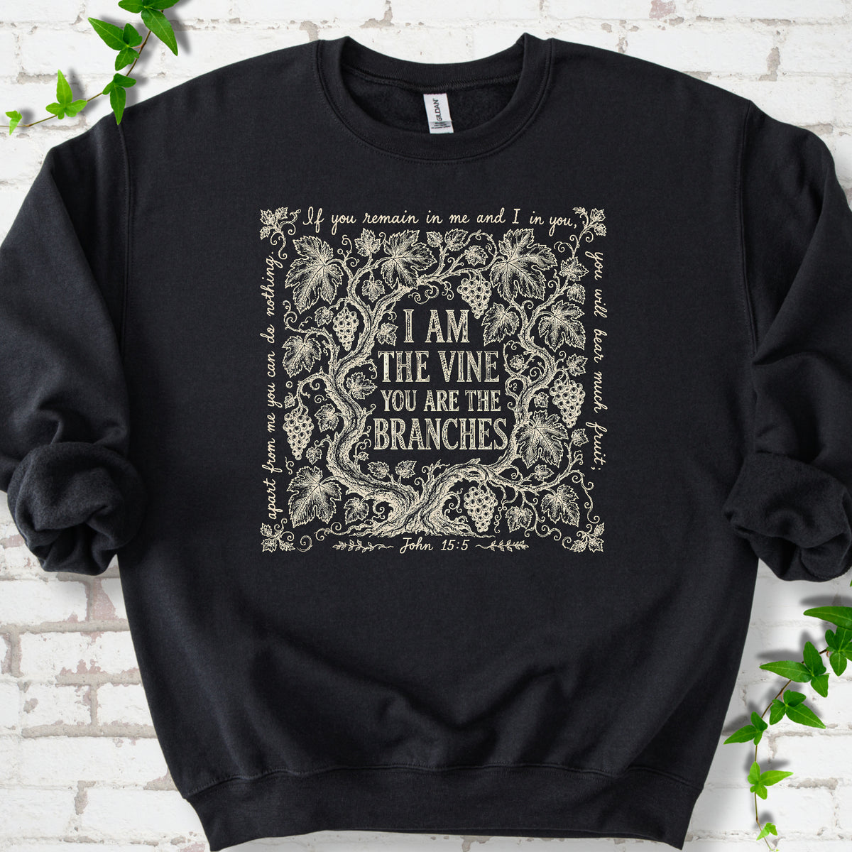 Black Gildan® 18000 crewneck sweatshirt flat lay featuring John 15:5 text framed by grapevines.